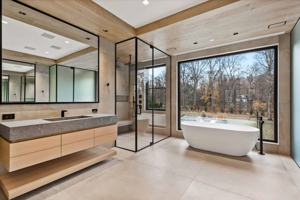 A bright, modern bathroom featuring a privacy-glass window and moisture-resistant materials. The window allows natural light while maintaining privacy, enhancing both comfort and ventilation. The clean installation showcases expert sealing and sleek European-style finishes.