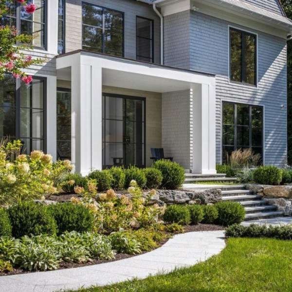 Contemporary aluminum front doors installed in a white luxury mansion, showcasing sleek minimalist design, clean lines, and a high-end architectural aesthetic.
