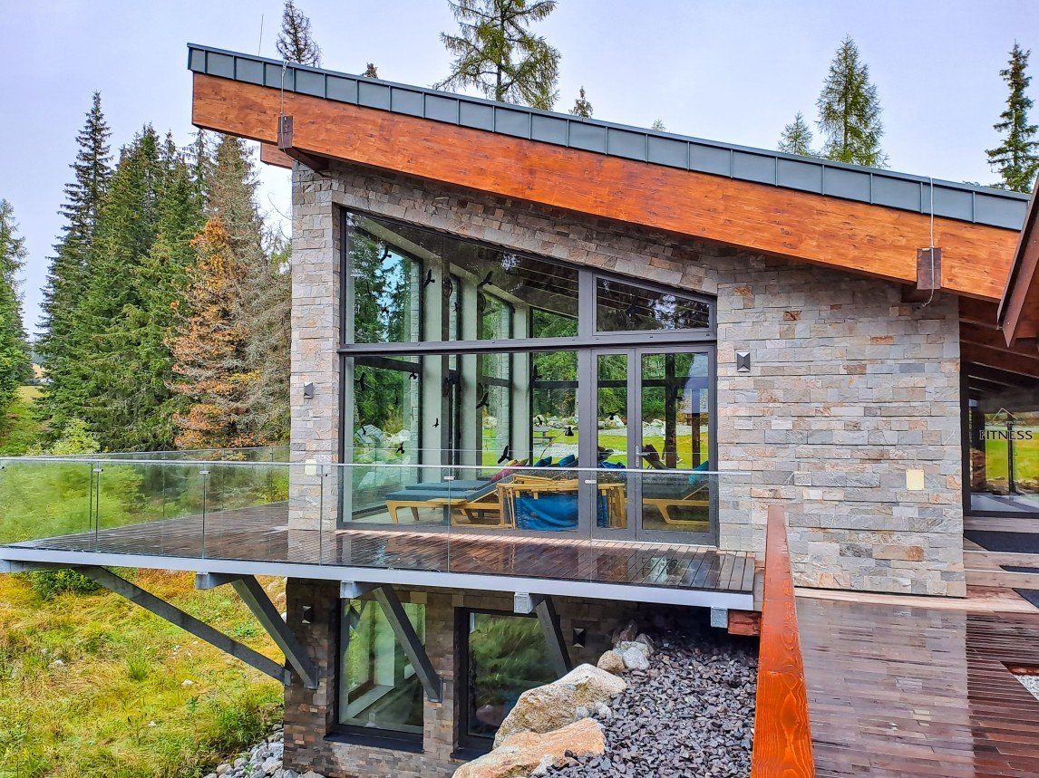 Charming cottage with professionally installed wood-framed windows, designed for natural light, insulation, and rustic style.